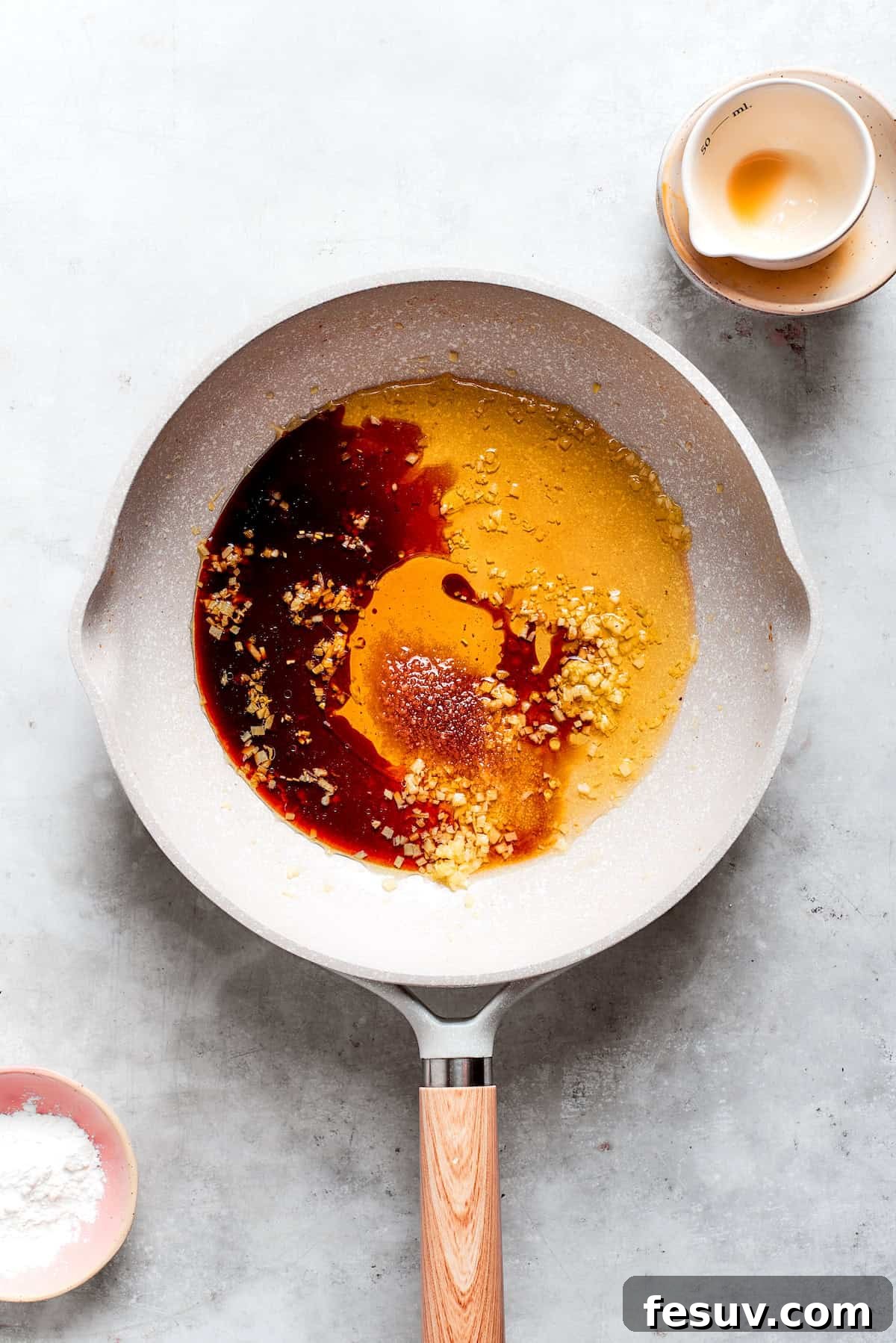 Teriyaki sauce ingredients are added to a pan.