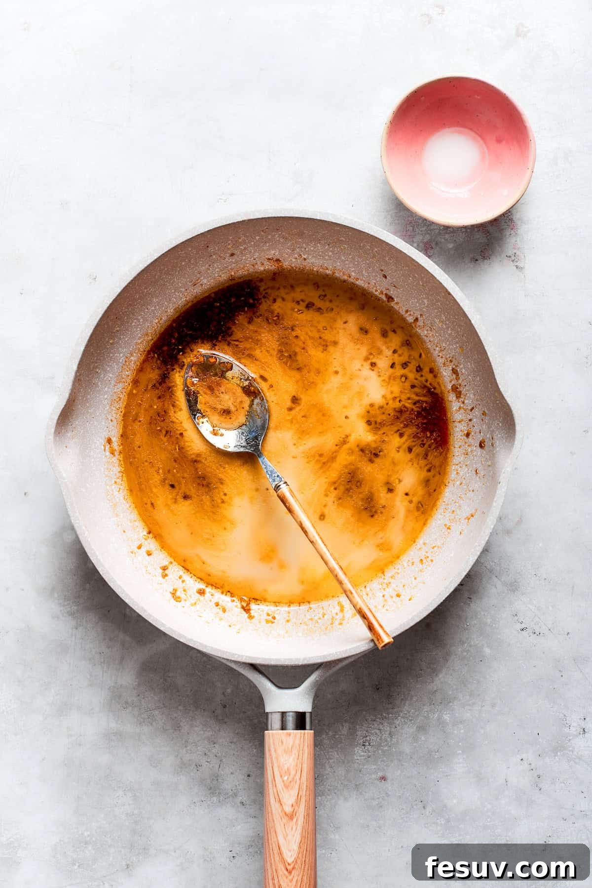 The sauce is stirred in a pan.