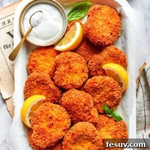 A serving tray with homemade chicken nuggets and a dish of ranch dressing and lemon slices.