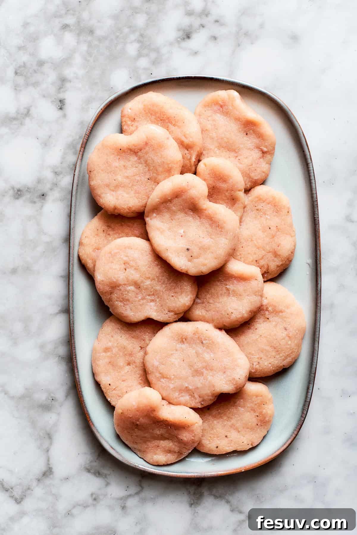The nuggets are formed and placed on a plate.