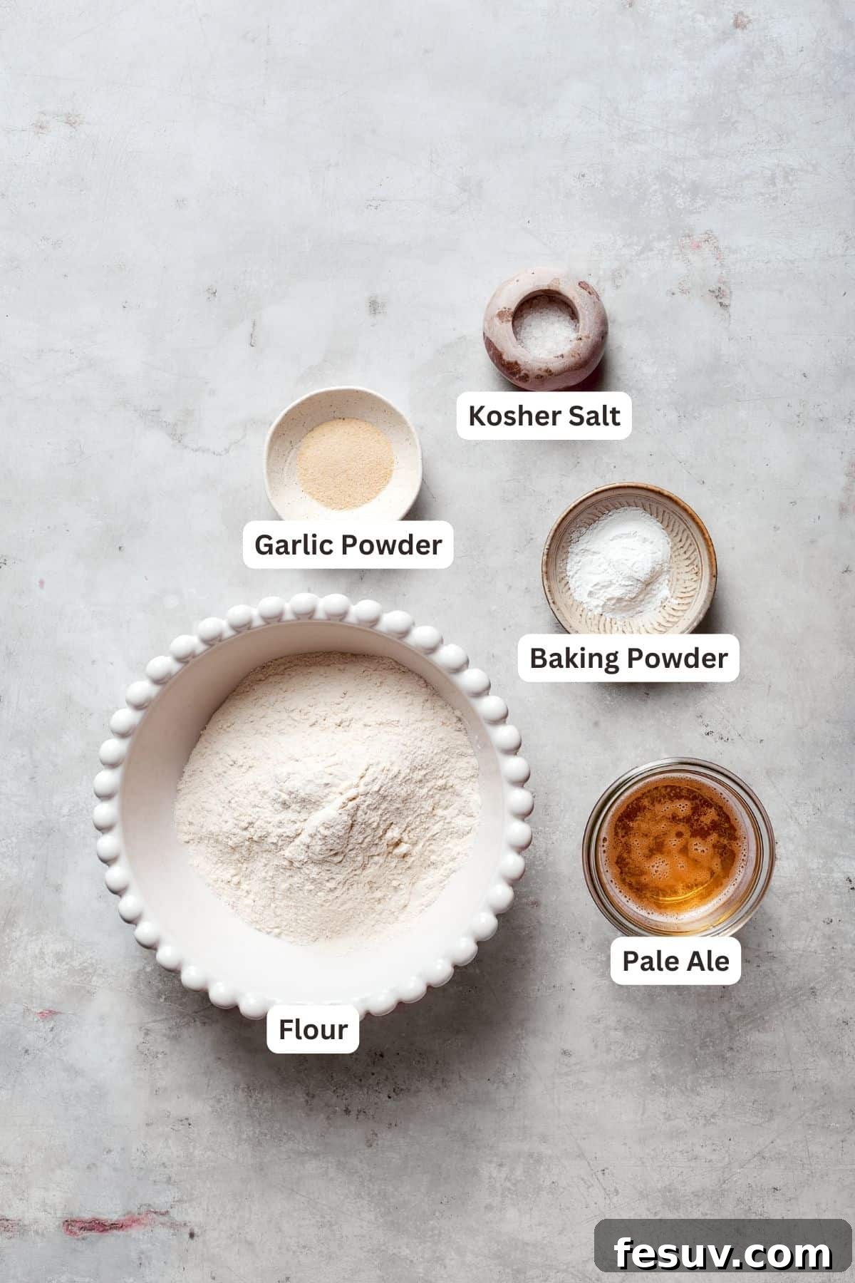 Labeled ingredients for beer battered fish, including flour, baking powder, salt, pepper, garlic powder, and a light beer.