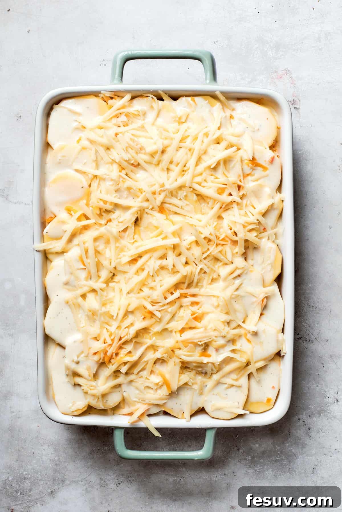 Hearty Beef & Potato Bake 8 The final layer of shredded cheese is generously scattered over the top of the assembled casserole, ready for baking to golden perfection.