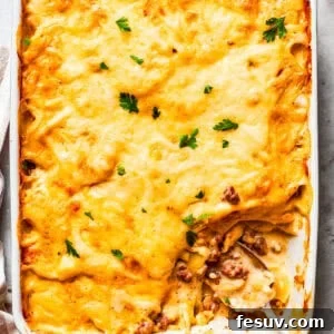 Hearty Beef & Potato Bake 10 Overhead image of hamburger potato casserole in a baking dish, with a serving of it missing from the corner.