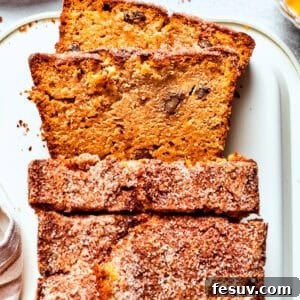 A loaf of Amish friendship bread with three slices cut from it, ready to be served.