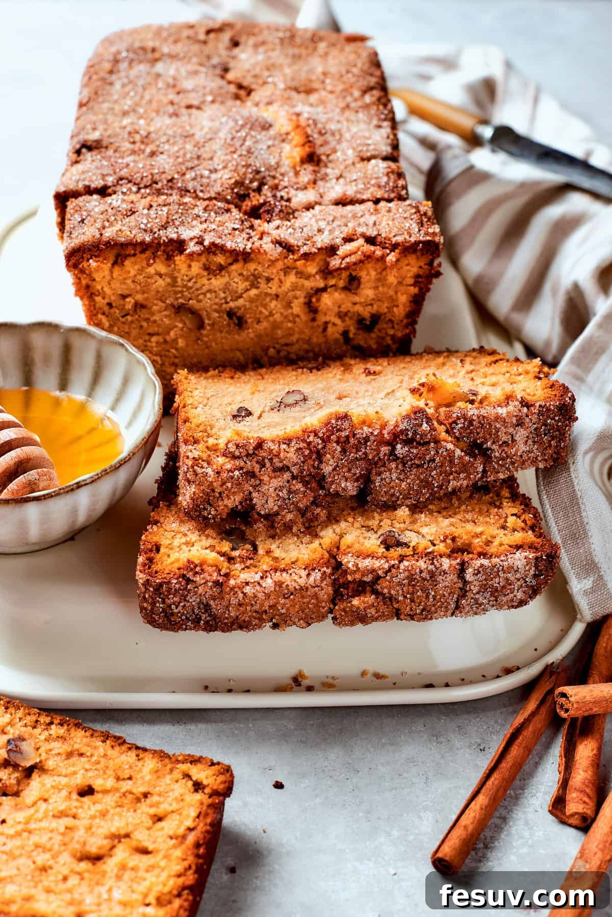 Slices of Amish friendship bread are buttered on a plate, ready to be enjoyed.