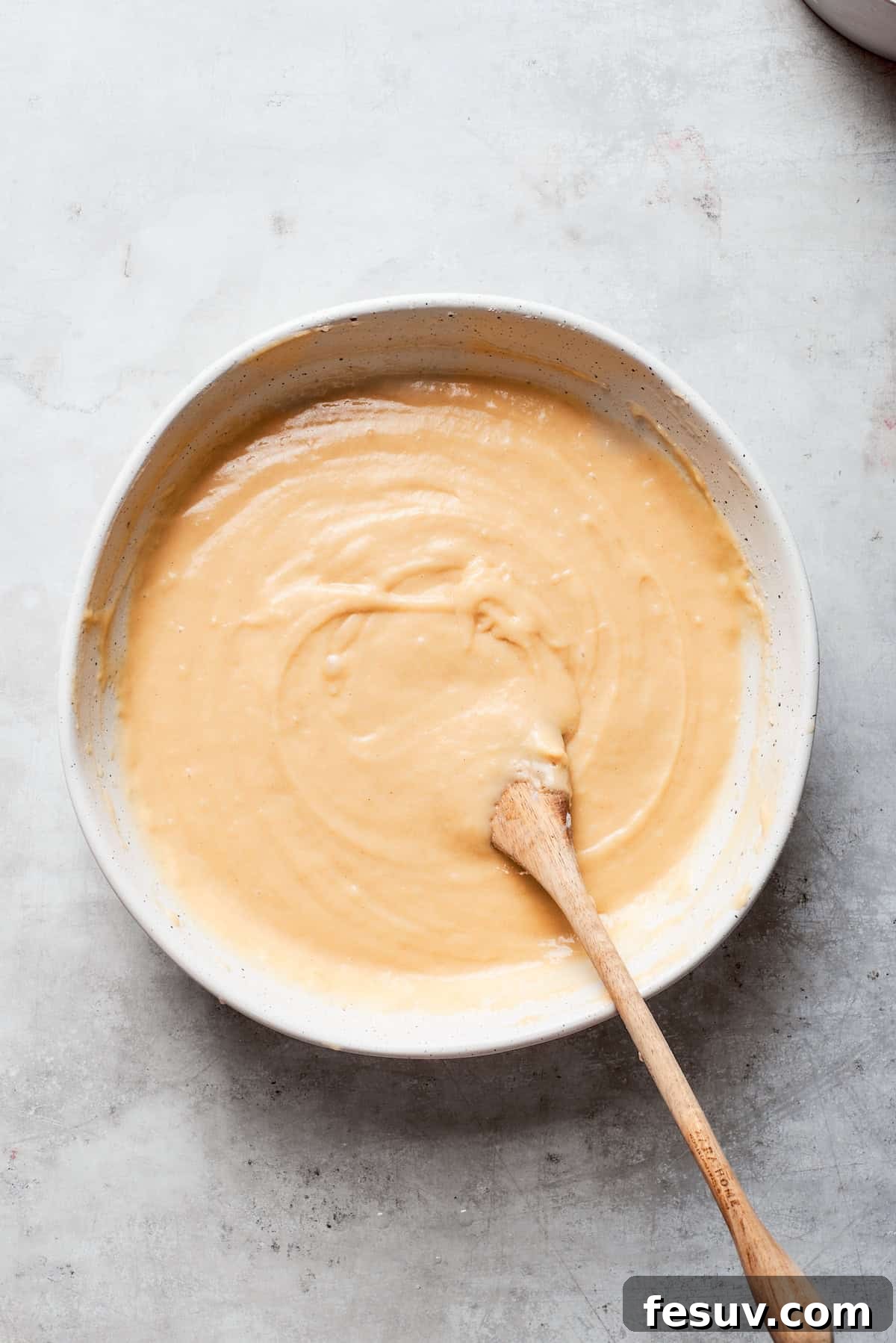 The batter is stirred until perfectly smooth, with no lumps of dry ingredients remaining.