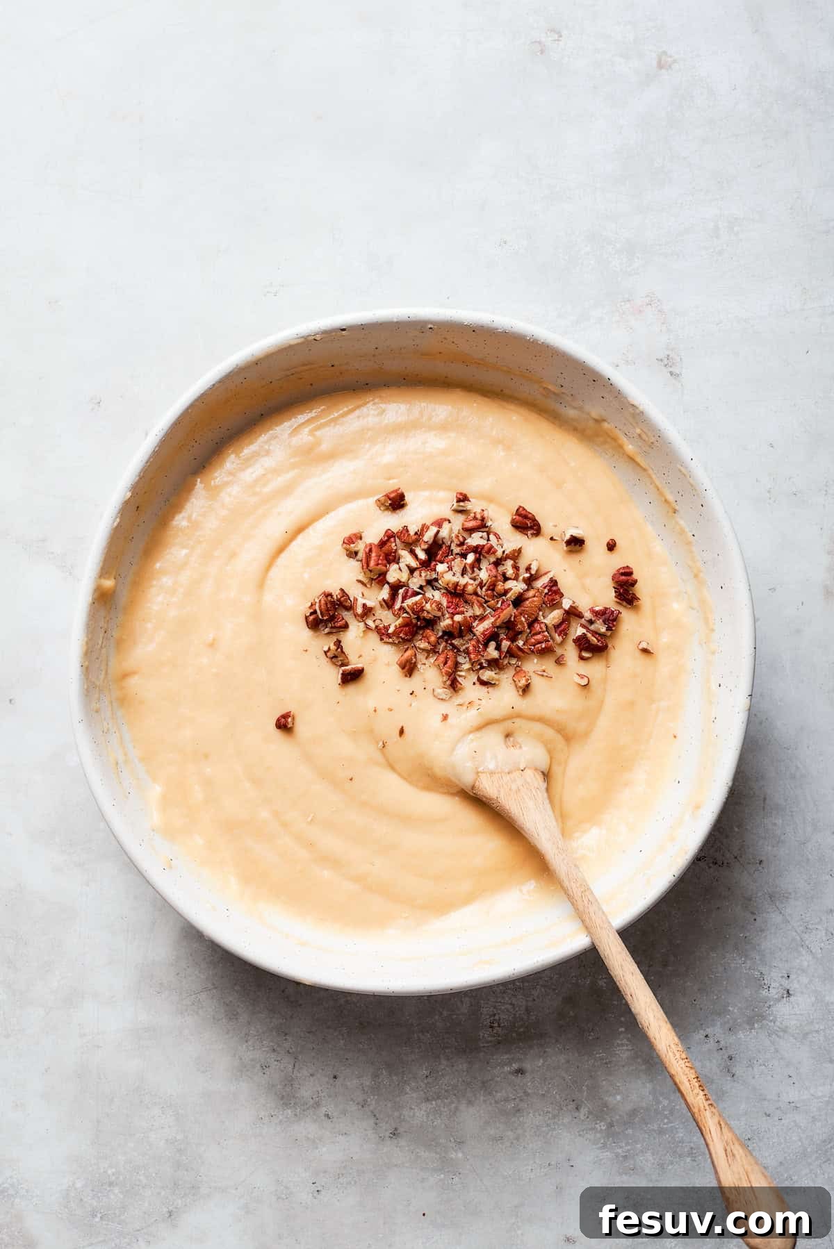 Toasted chopped pecans are gently folded into the smooth bread batter.