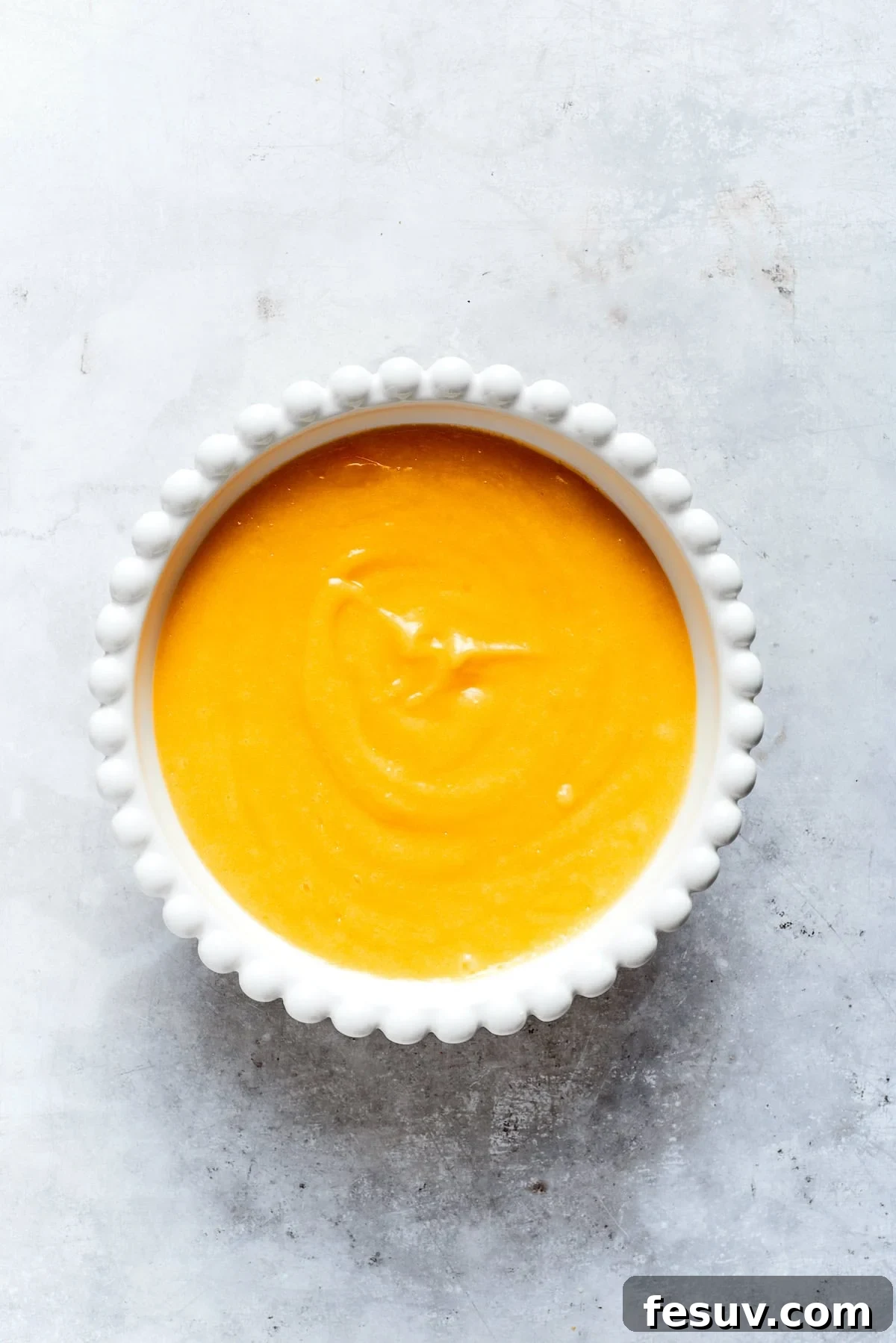 Sun-Kissed Lemon Tiramisu 11 Smooth, vibrant yellow lemon curd resting in a clear bowl after being freshly prepared.