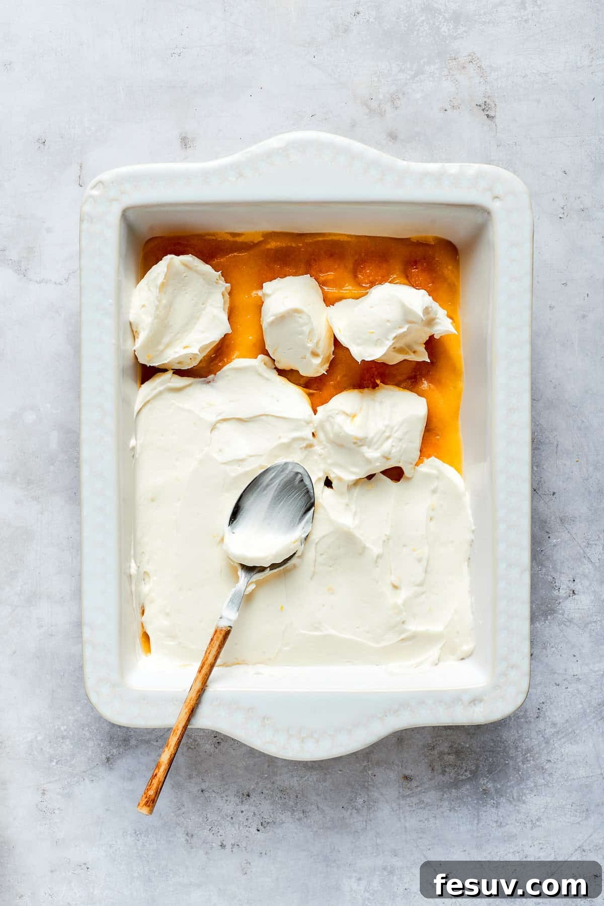Sun-Kissed Lemon Tiramisu 16 A generous, smooth layer of mascarpone cream filling spread evenly over the lemon curd and ladyfingers.