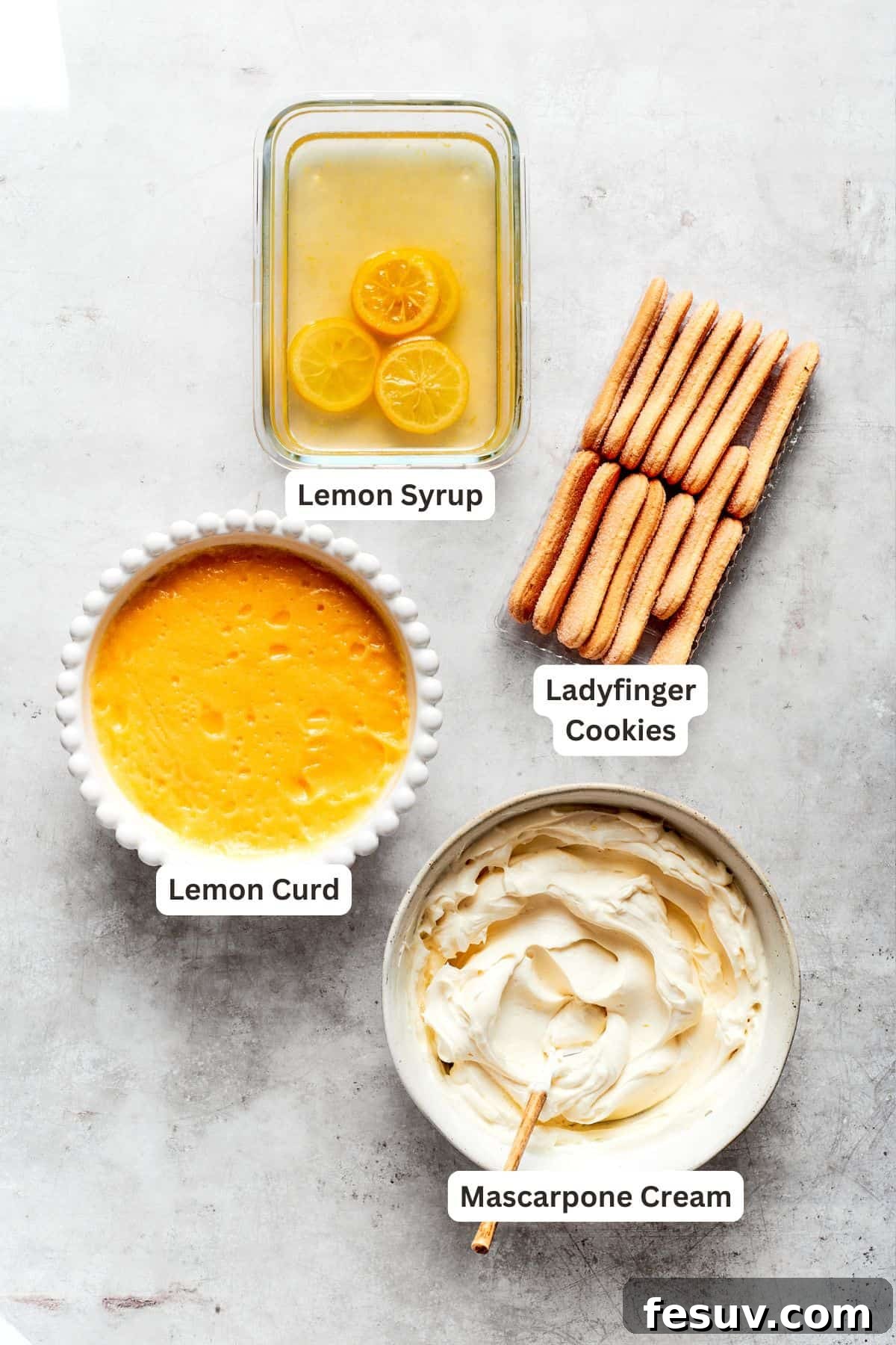 Sun-Kissed Lemon Tiramisu 6 Assembled ingredients for lemon tiramisu: ladyfinger cookies, bowl of lemon curd, bowl of mascarpone cream filling, and a glass of lemon syrup.