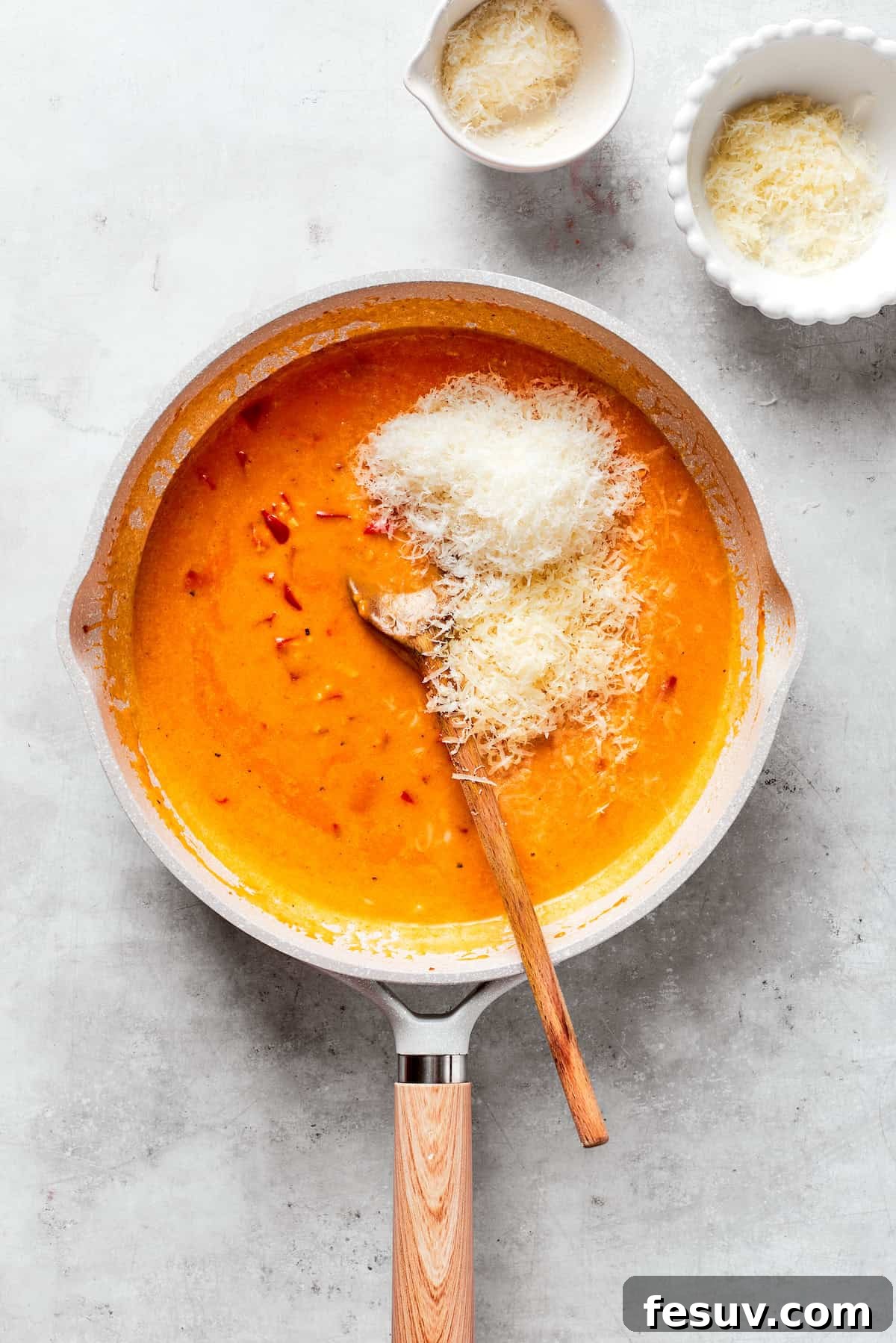 Cheeses are added to a creamy tomato sauce.