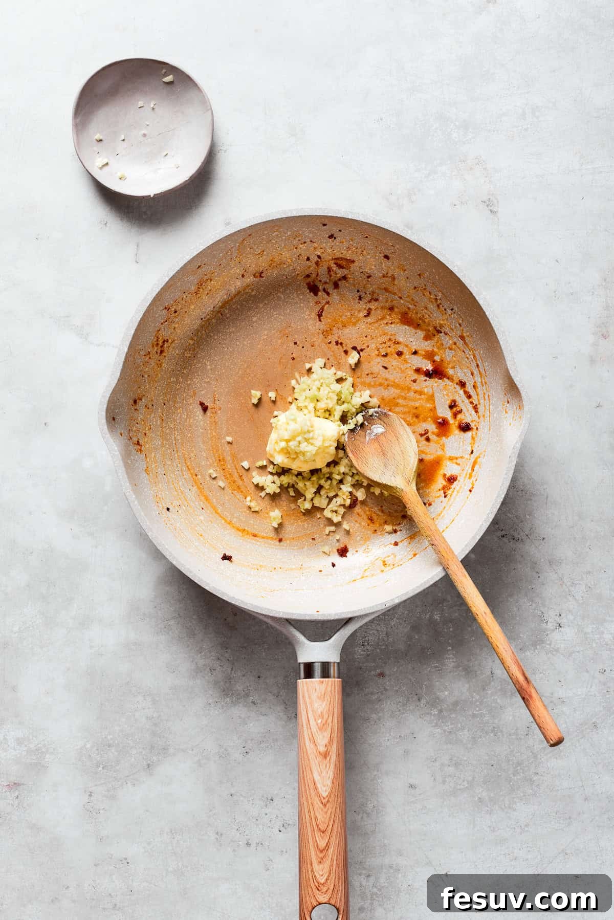 Butter is melted into a skillet with garlic.