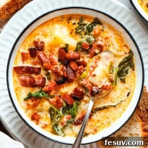 Creamy Tuscan Sausage and Kale Soup 3 A bowl of Zuppa Toscana served in a bowl and garnished with crumbled bacon.