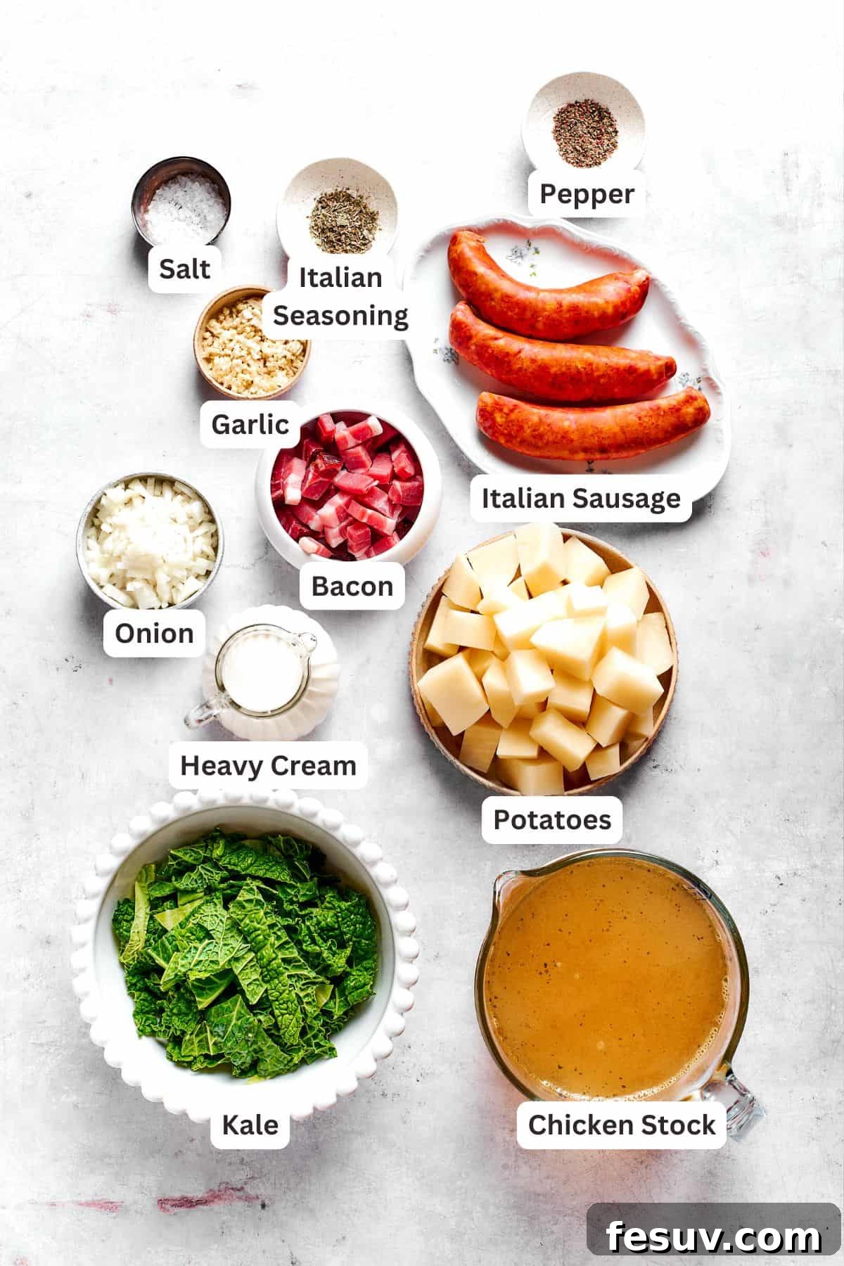 My Zuppa Toscana recipe features Italian sausage, bacon, potatoes, and kale in a savory broth. It’s an easy copycat version of the Olive Garden classic! All the essential ingredients for Zuppa Toscana laid out and clearly labelled: Italian sausage, bacon, chicken broth, various spices, fresh garlic, onion, Yukon Gold potatoes, kale, and heavy cream.