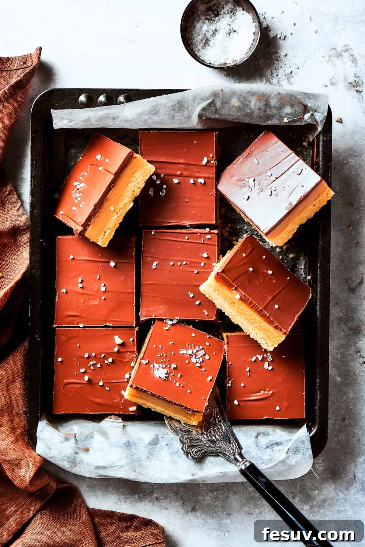 A square pan of freshly made Millionaire bars, ready for cutting.