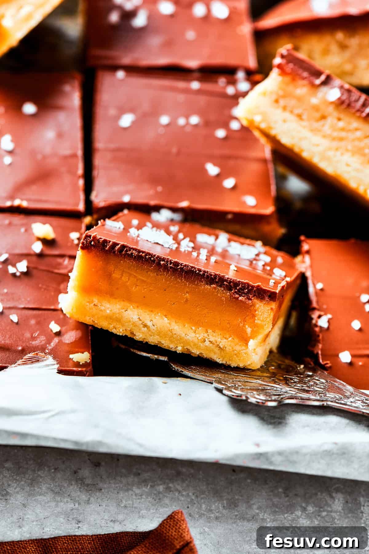 A side view of a generous pile of millionaire bars, showing off the perfectly layered structure.
