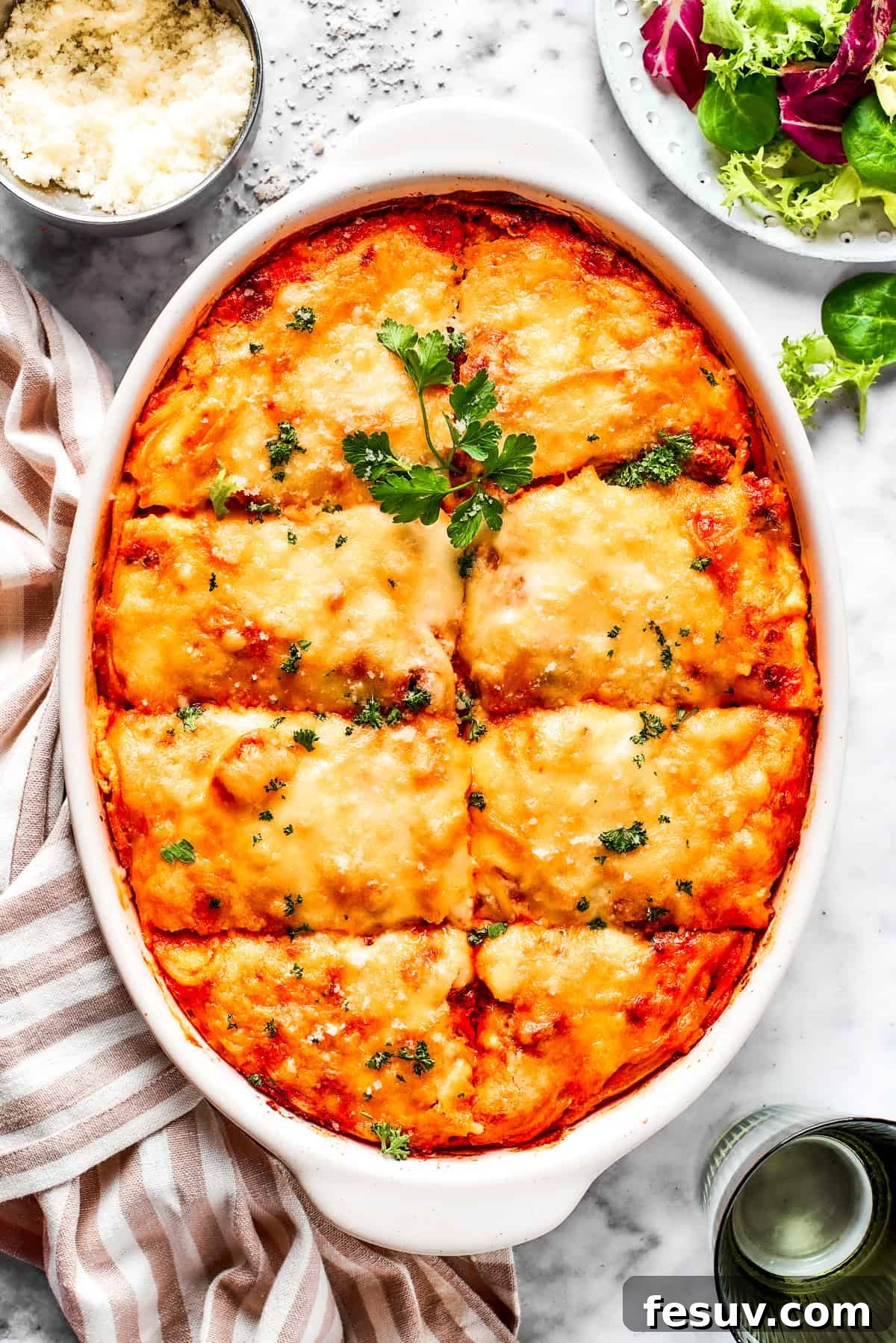Million Dollar Spaghetti: A Cheesy Baked Pasta Casserole Overhead image of baked Million Dollar Spaghetti in a casserole dish, showcasing its golden cheese crust and rich texture.