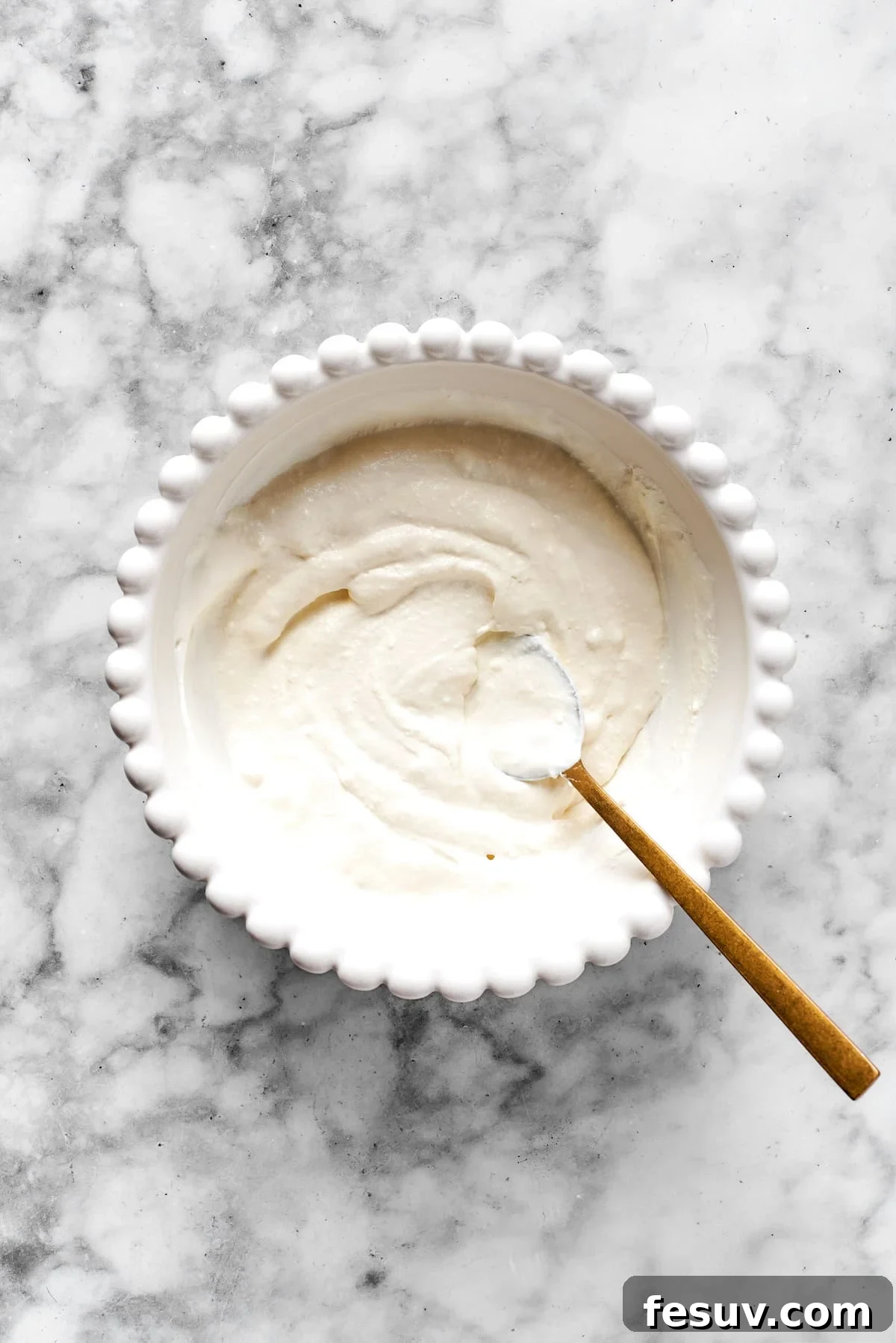 Achieving the Perfect Cheese Mixture Texture A smooth, well-mixed cheese mixture in a white bowl, showing the ideal creamy texture.