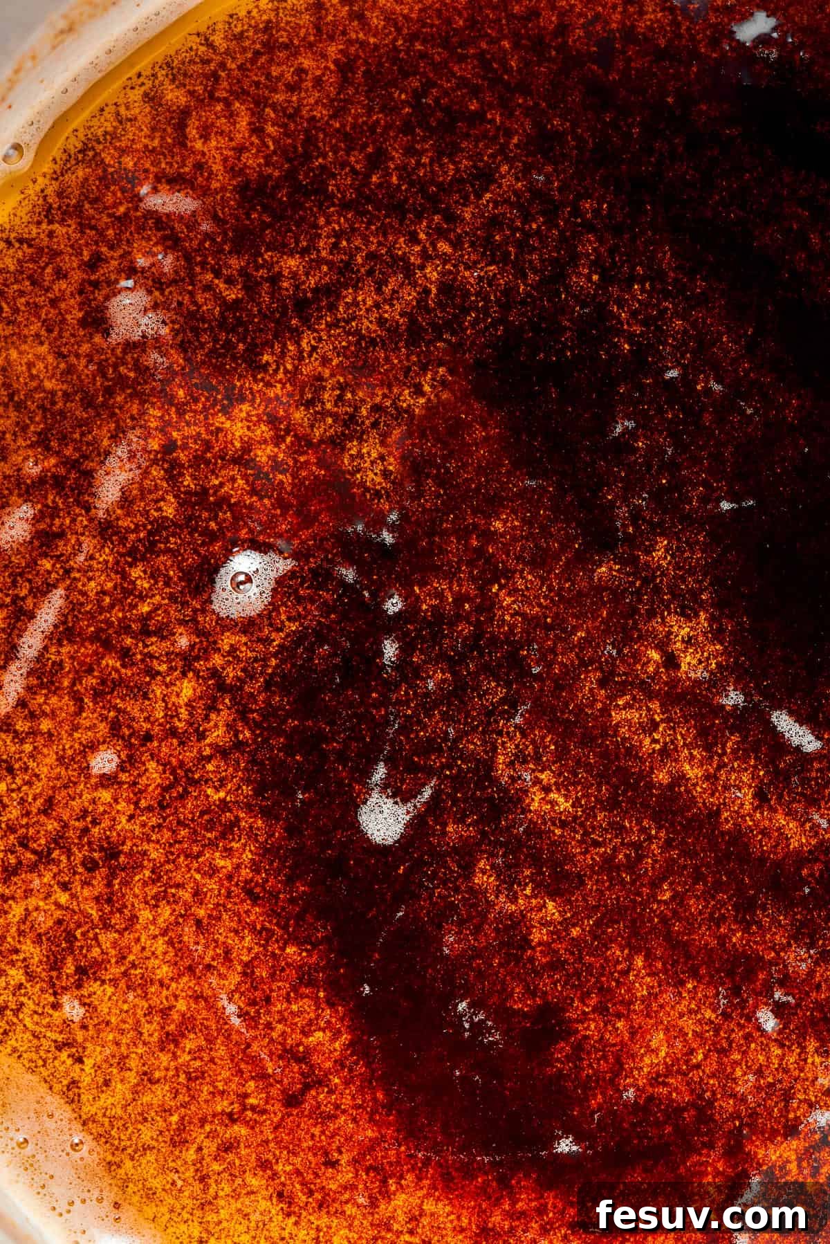Close-up of golden toasted milk solids at the bottom of a pan, indicating perfectly browned butter.