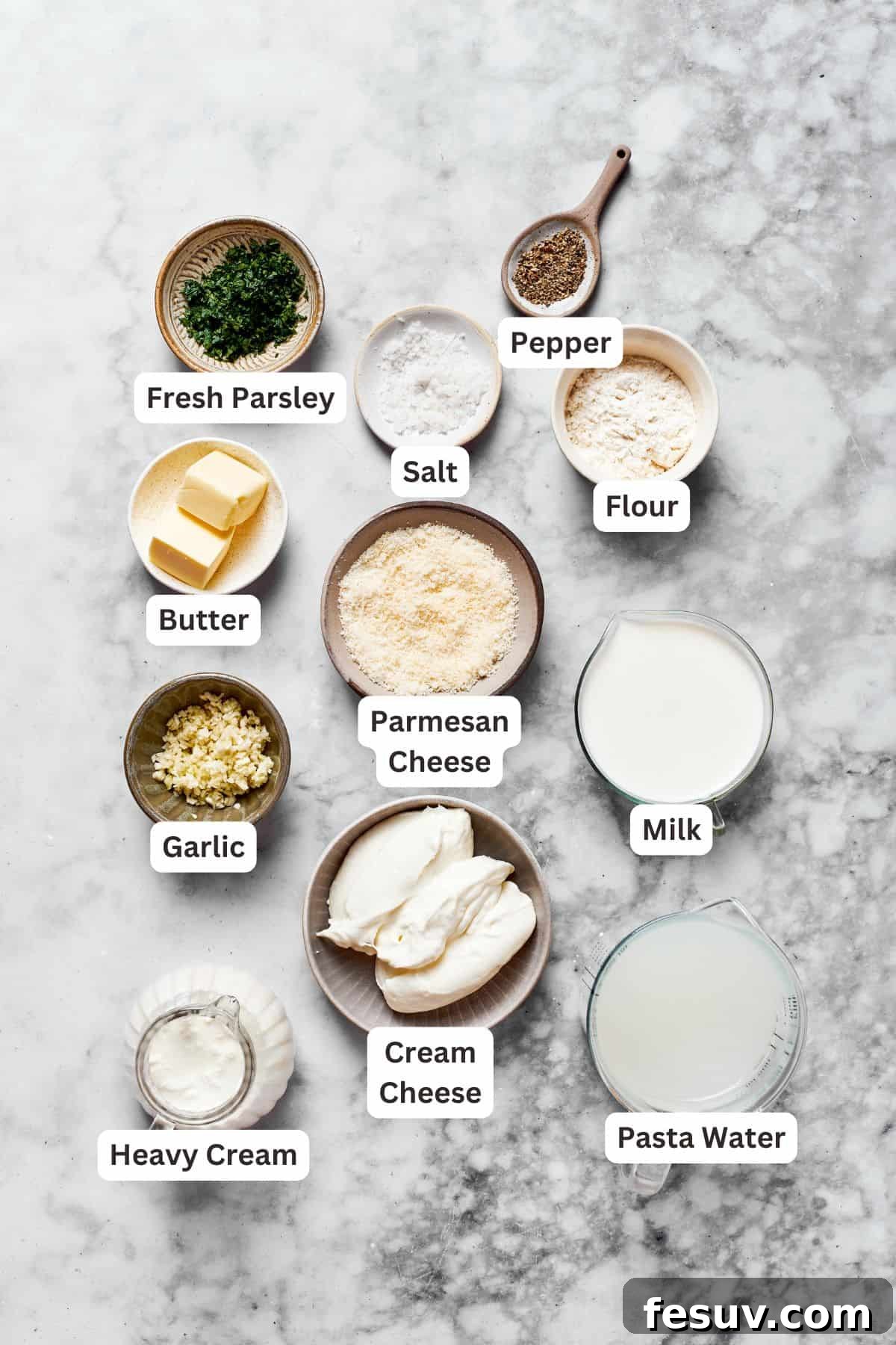 The foundation ingredients for our incredibly rich and creamy garlic Parmesan sauce. Ingredients for the rich and creamy garlic parmesan sauce, featuring unsalted butter, all-purpose flour, milk, heavy cream, freshly shredded Parmesan cheese, and cubed cream cheese.