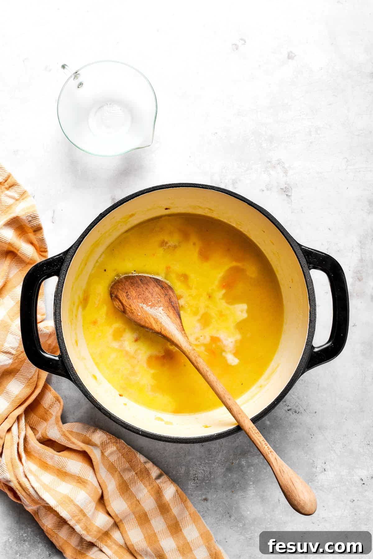 Adding milk to the pot.