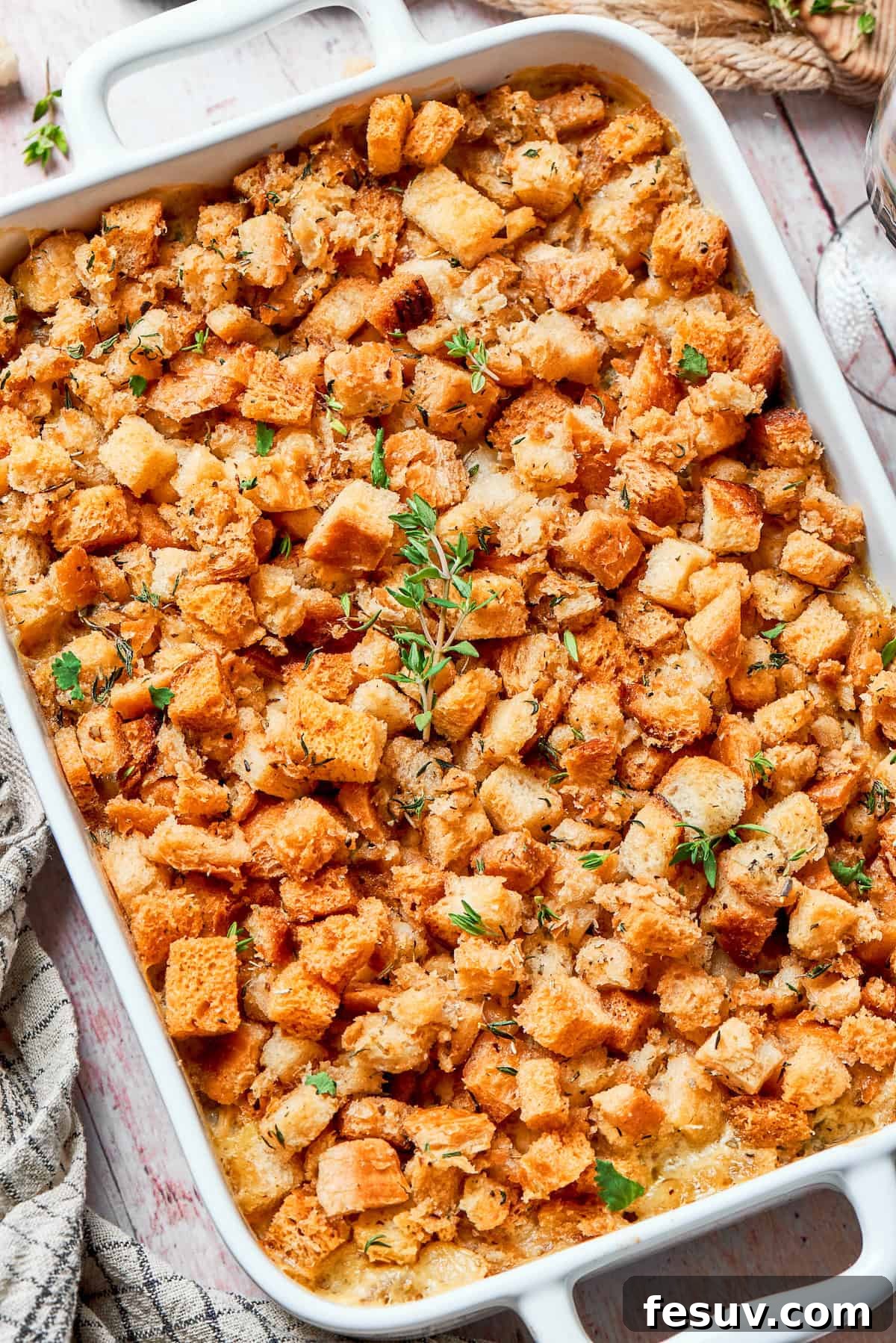 Baked chicken stuffing casserole in a 9x13 dish, golden and bubbly.
