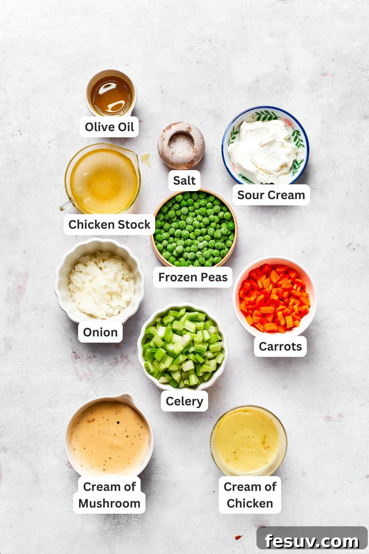 Ingredients for chicken filling including olive oil, onion, carrots, celery, salt, cream of chicken soup, cream of mushroom soup, sour cream, chicken stock, frozen peas, and black pepper.