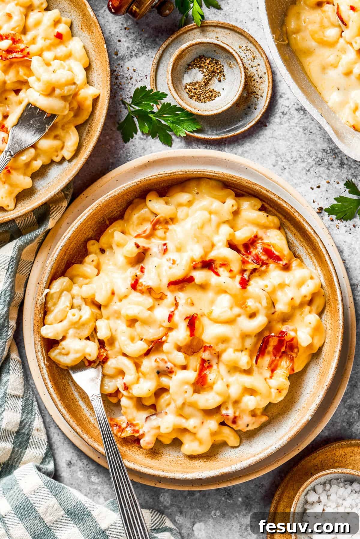 Individual servings of creamy bacon mac and cheese presented in charming rustic bowls, ready for a comforting meal.
