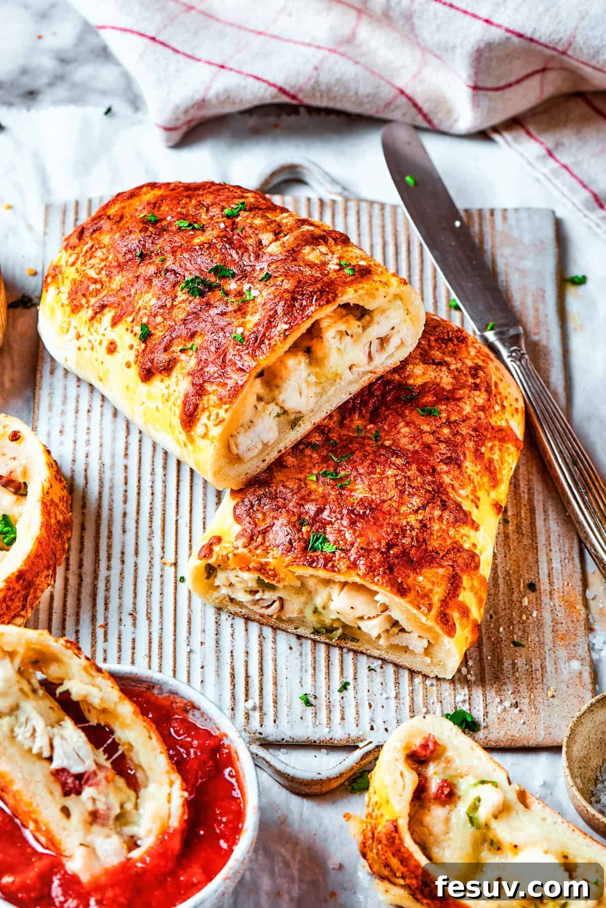 Two halved chicken bake sandwiches stacked one on top of the other, showcasing the abundant filling.
