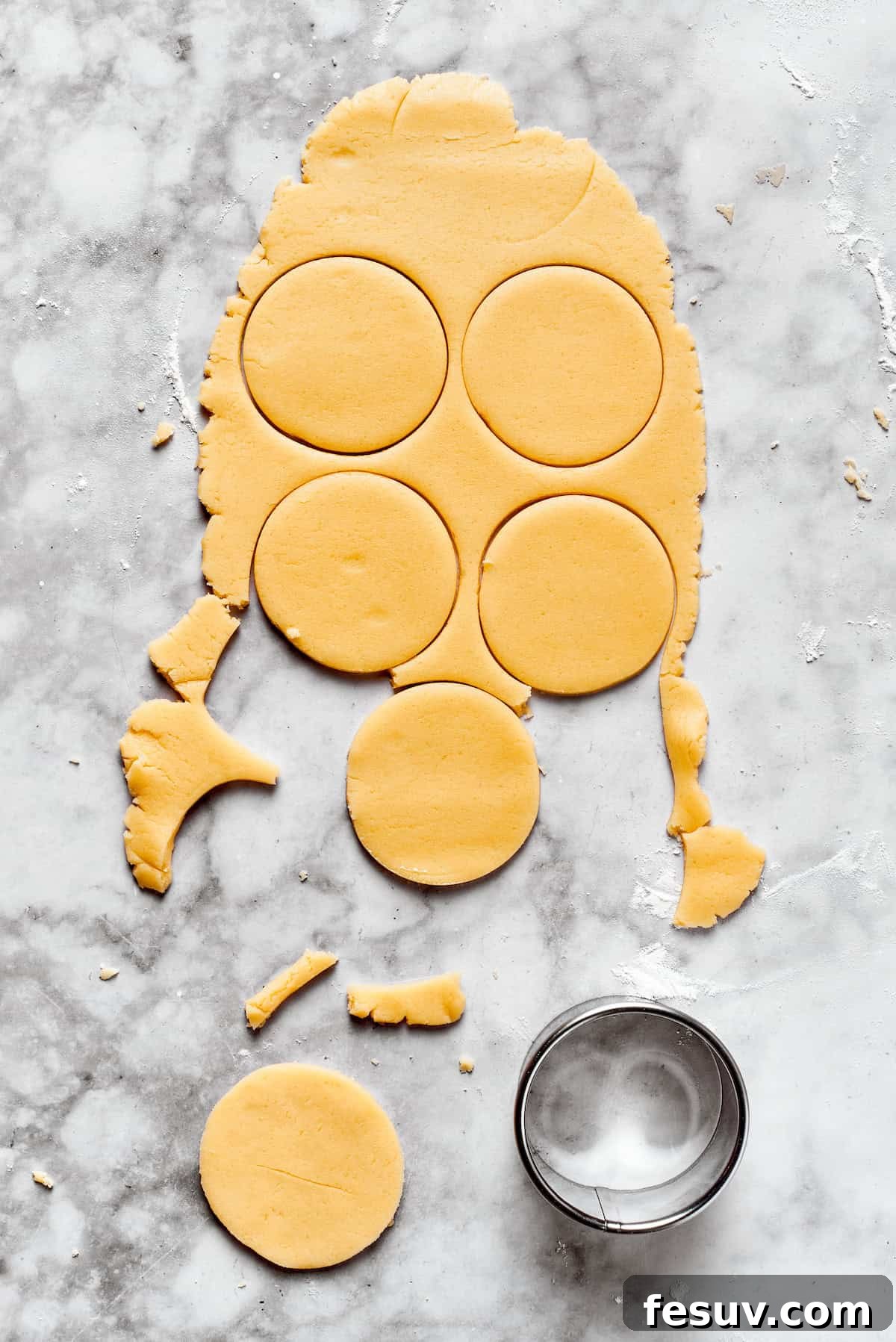The cutest Melted Snowman Cookies top buttery homemade sugar cookies with a thick vanilla frosting and a fluffy marshmallow! Sugar cookie dough perfectly cut into uniform round shapes using a cookie cutter.