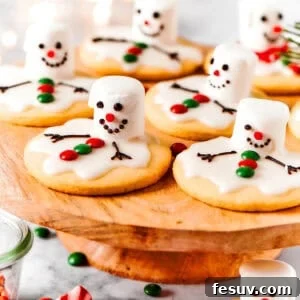 Snowman Meltdown Cookies 2 Melting snowman cookies are arranged on a cake plate.