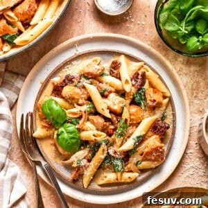 A plate of Marry Me Chicken Pasta garnished with fresh basil, showcasing its creamy texture and rich appearance.