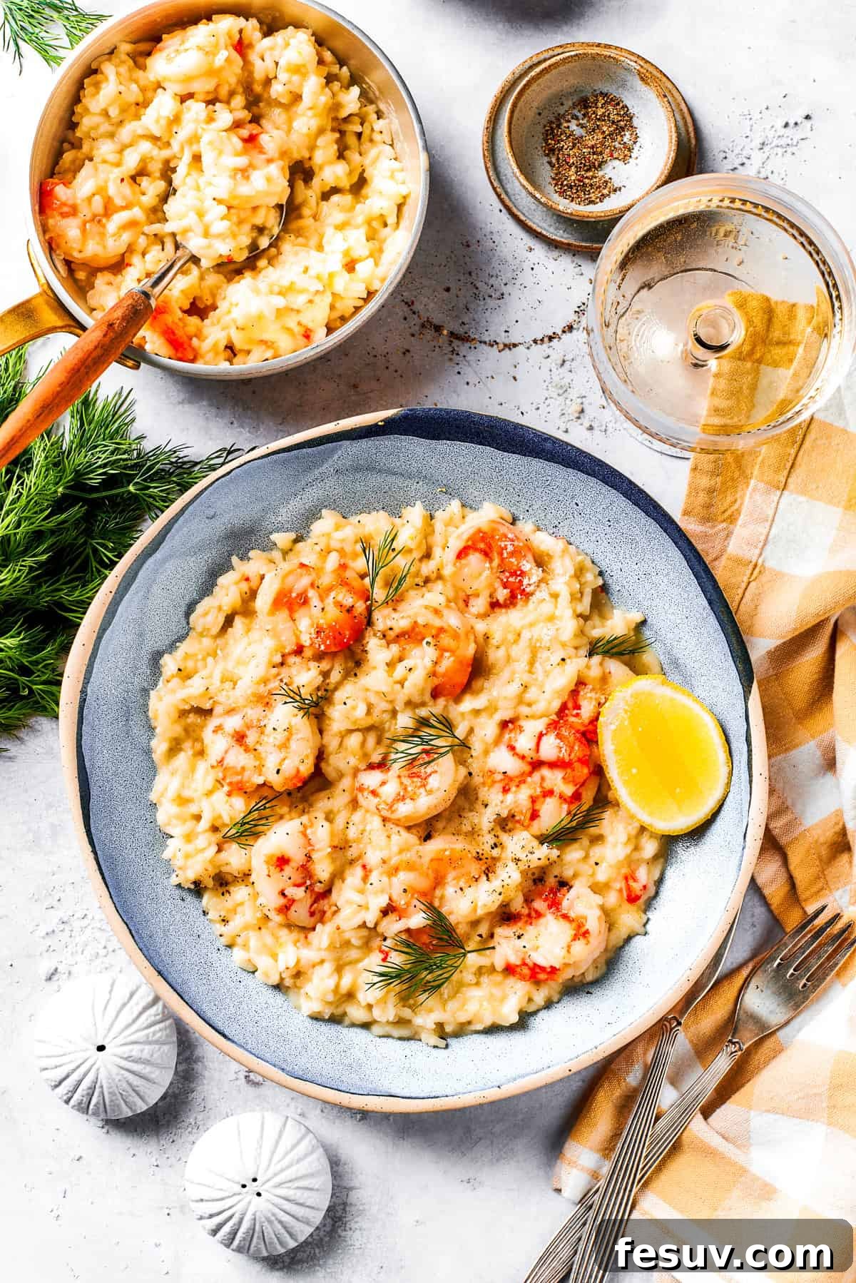 A serving of creamy shrimp risotto on a dinner plate, garnished with fresh herbs.