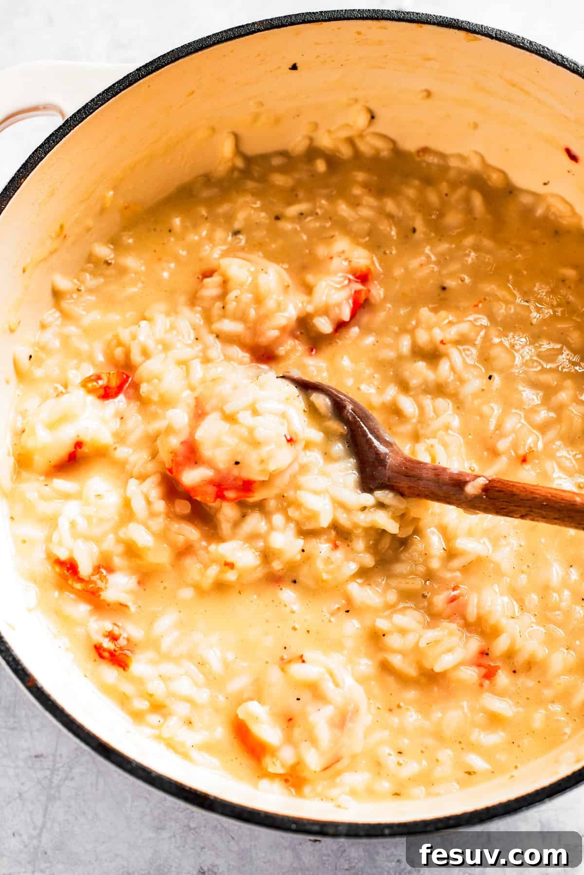 A large pot of perfectly cooked, creamy shrimp risotto, ready to be served.