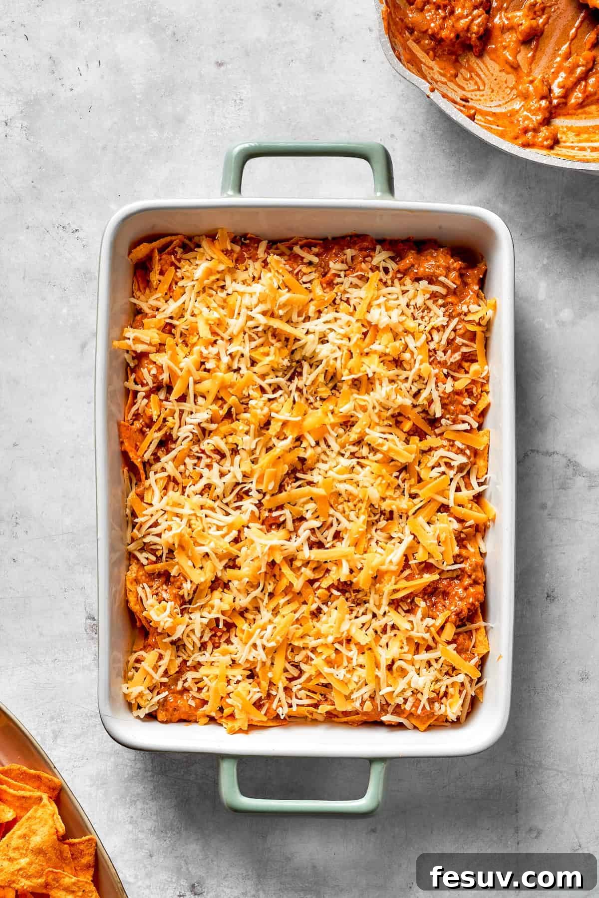 A freshly baked Dorito casserole, golden and bubbly with melted cheese, resting in its baking dish after coming out of the oven.