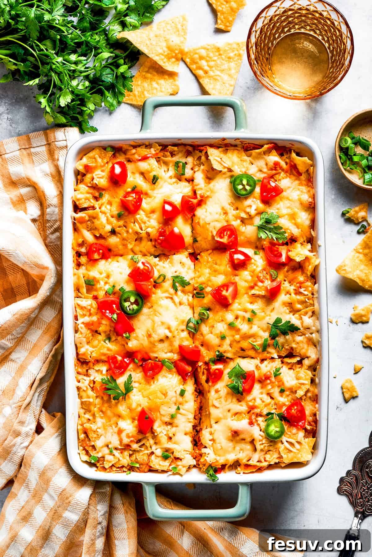 A baked Dorito casserole, neatly cut into six individual slices, arranged in a vibrant red baking dish, ready to be served.