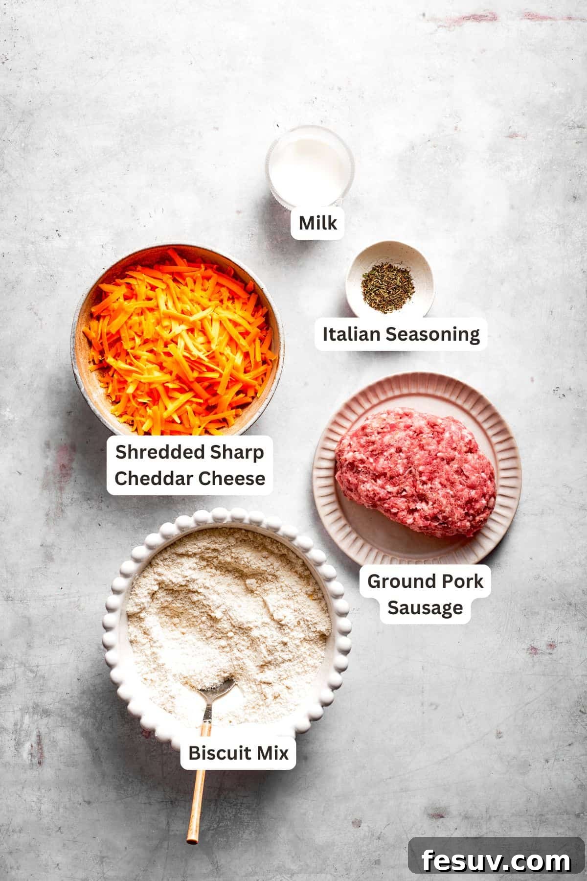 This sausage balls recipe relies on Bisquick, pork sausage, and Italian seasoning for an easy appetizer. Don't forget the dipping sauce! The ingredients for sausage balls are text-labeled.