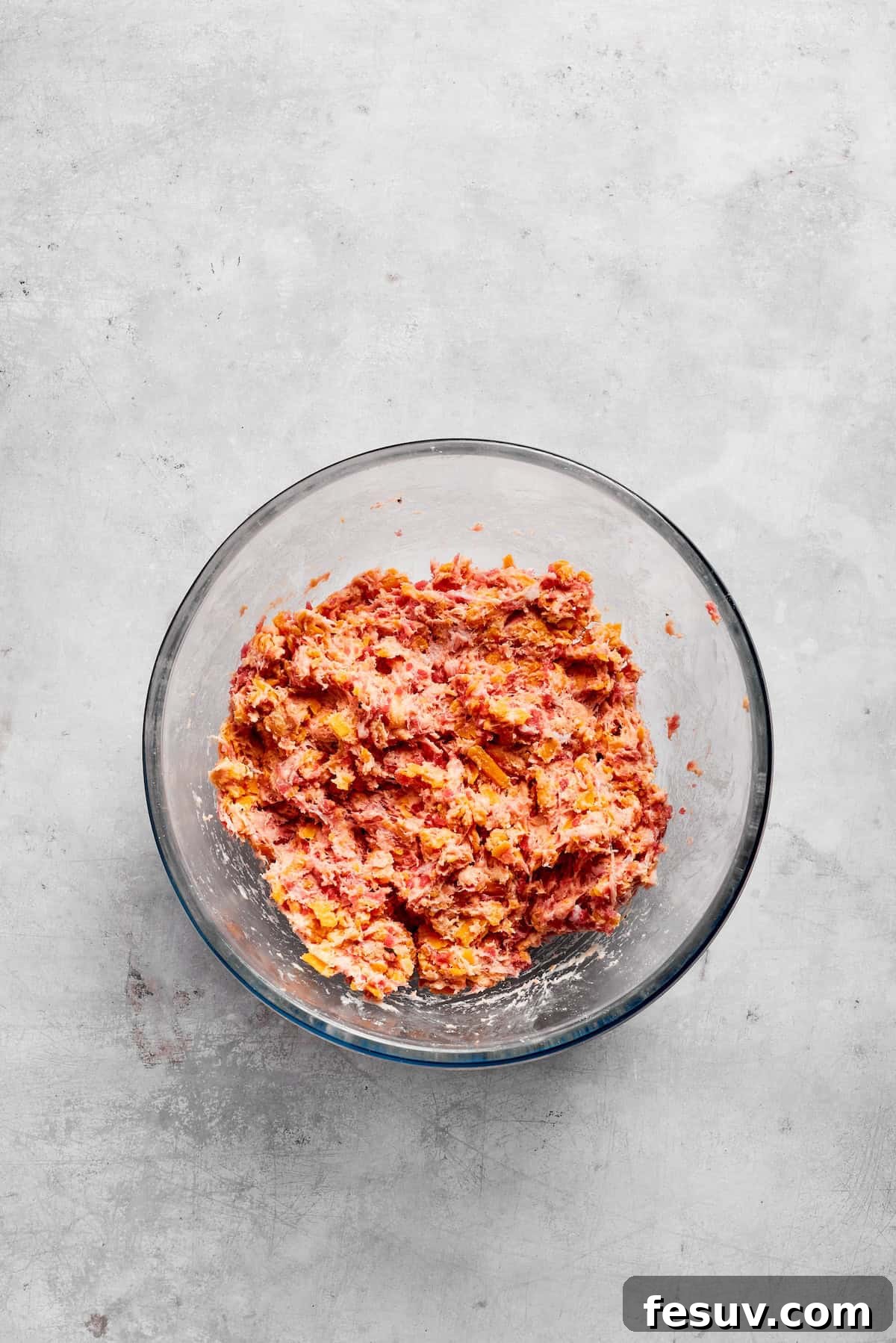 This sausage balls recipe relies on Bisquick, pork sausage, and Italian seasoning for an easy appetizer. Don't forget the dipping sauce! Sausage balls mixed together in a bowl.