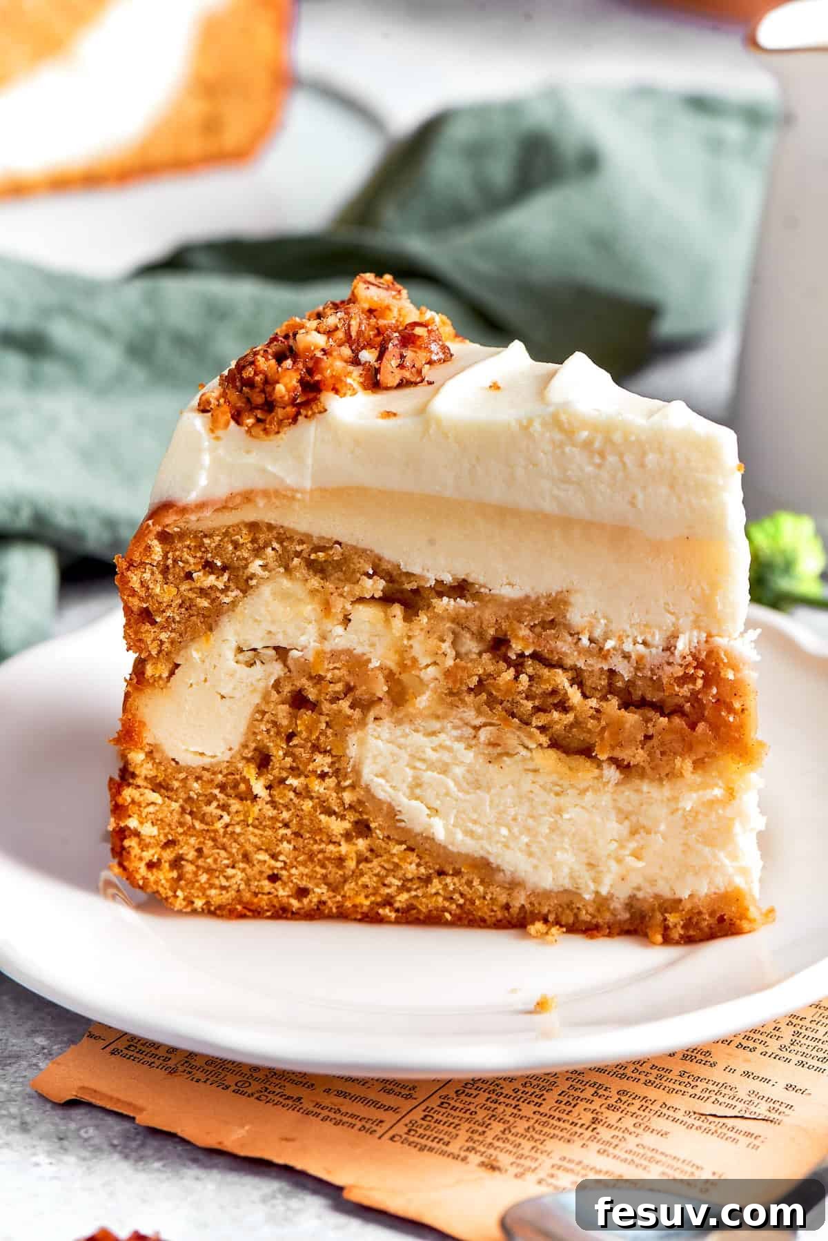 A thick slice of carrot cake cheesecake on a plate, showcasing its distinct layers.