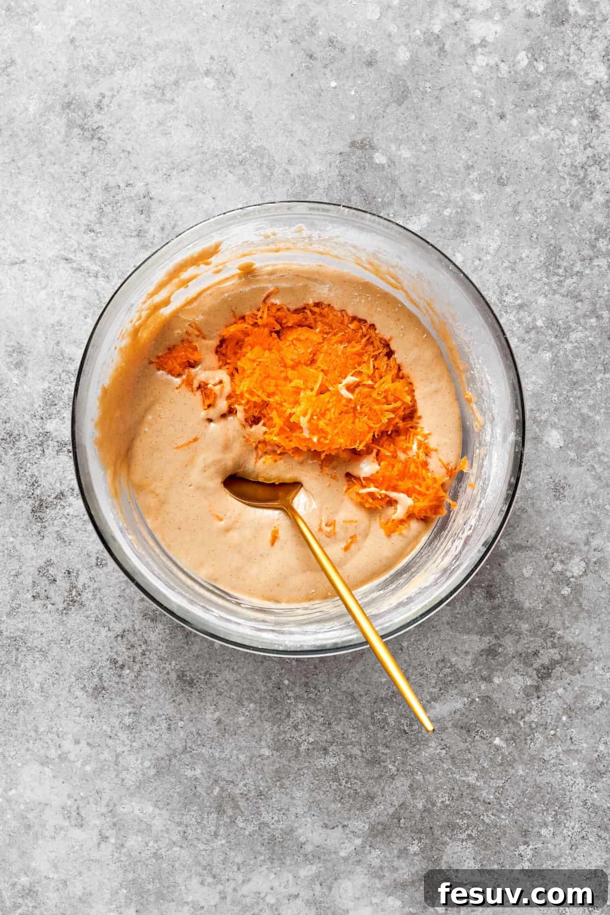 Carrots are added to carrot cake batter.