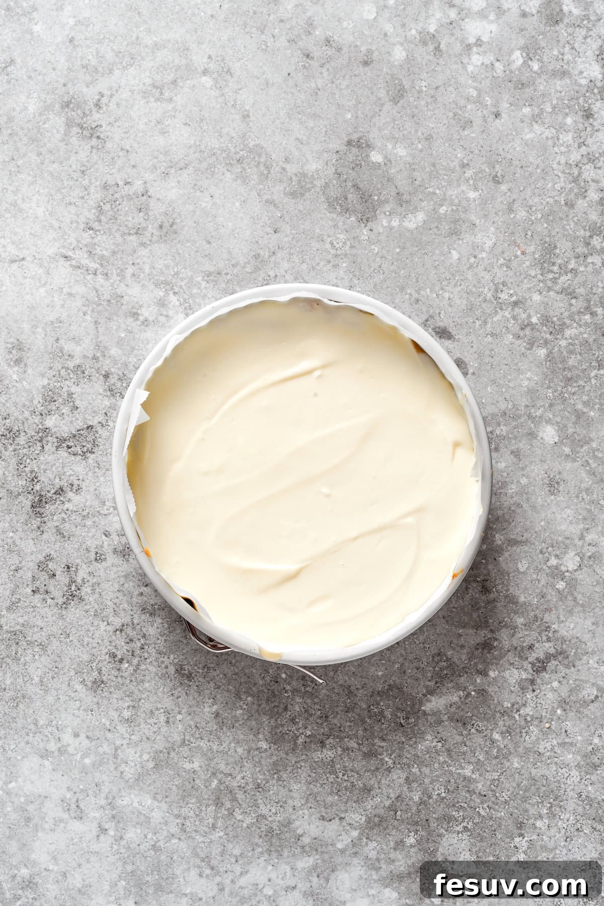 Cheesecake batter is added to carrot cake batter.