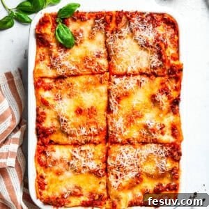 A pan of beef lasagna cut into squares.