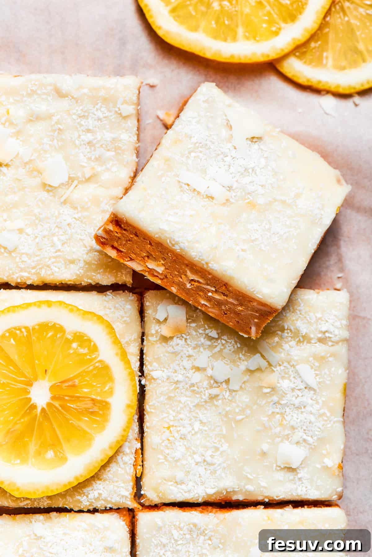 Perfectly cut squares of lemon slice, showcasing the creamy lemon topping and crumbly base.