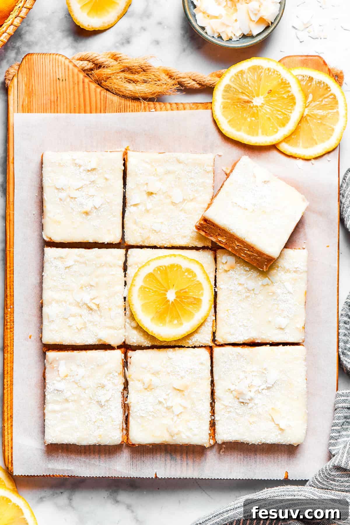 Rows of perfectly frosted lemon slice squares ready to be served.