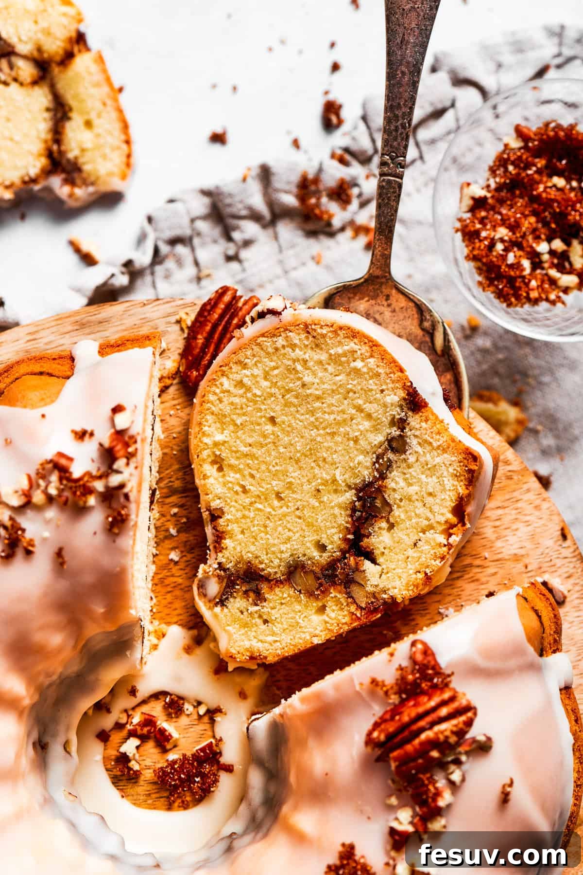 The 'Just One More' Cake 6 A delectable slice of Sock It To Me Cake prominently displaying its signature cinnamon sugar and pecan ribbon.