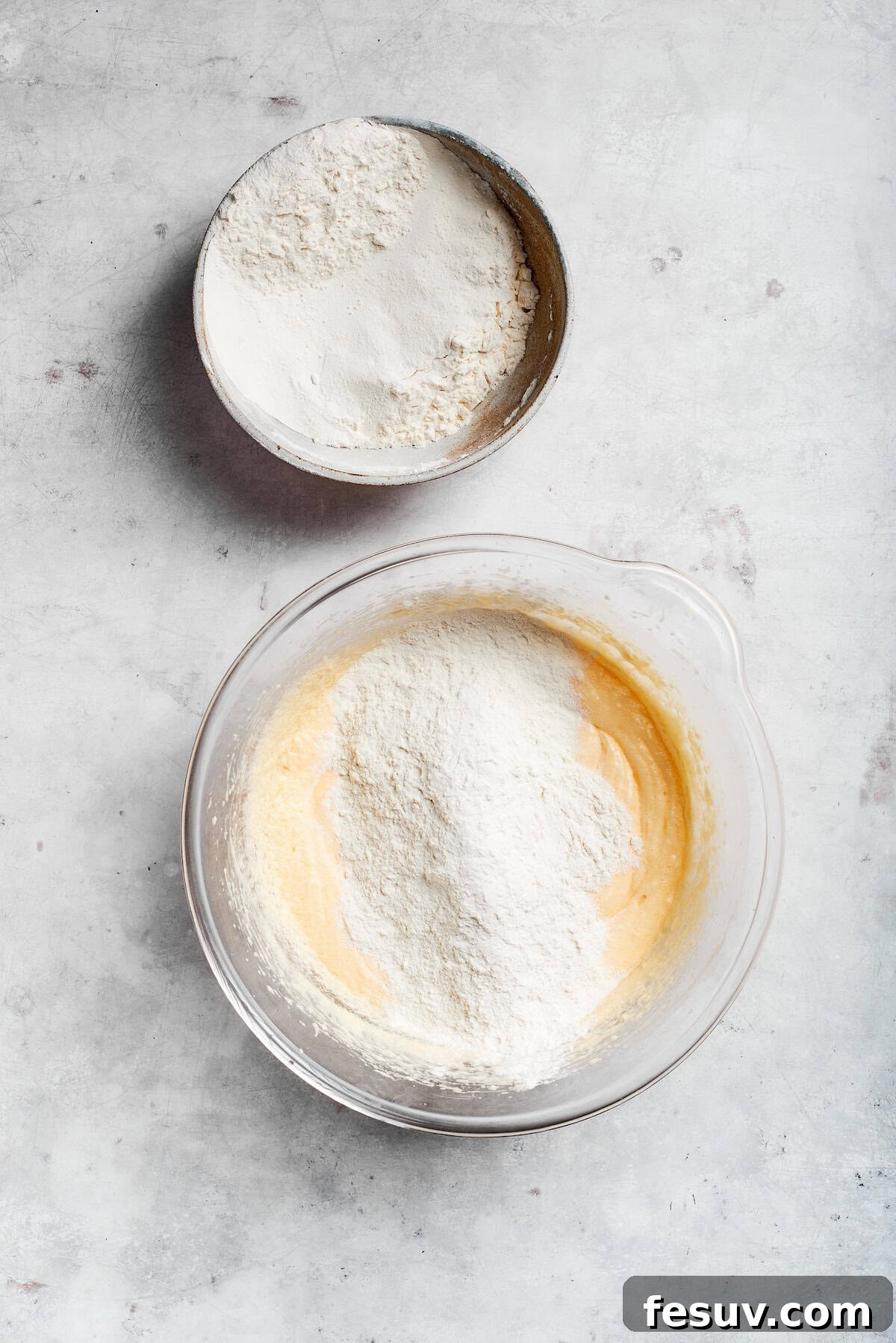 The 'Just One More' Cake 9 Dry flour mixture being gently folded into the wet cake batter until just combined.