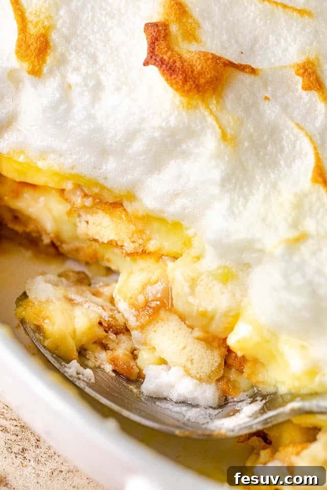 Southern Comfort Banana Pudding 5 side view of scooping out a portion of homemade banana pudding dessert from a dish