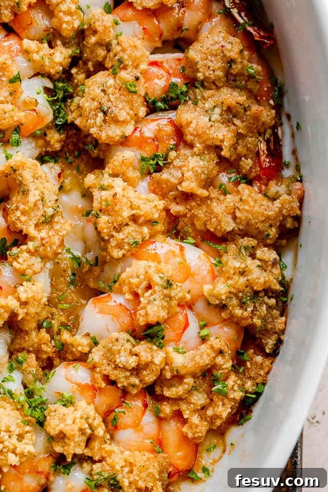 Garlic Butter Baked Shrimp De Jonghe 3 close up shot of garlic butter baked shrimp in a white dish.