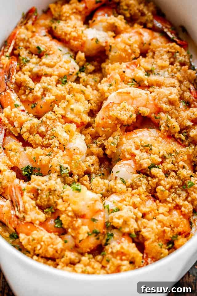 Garlic Butter Baked Shrimp De Jonghe 6 Baked shrimp in a white oval dish.