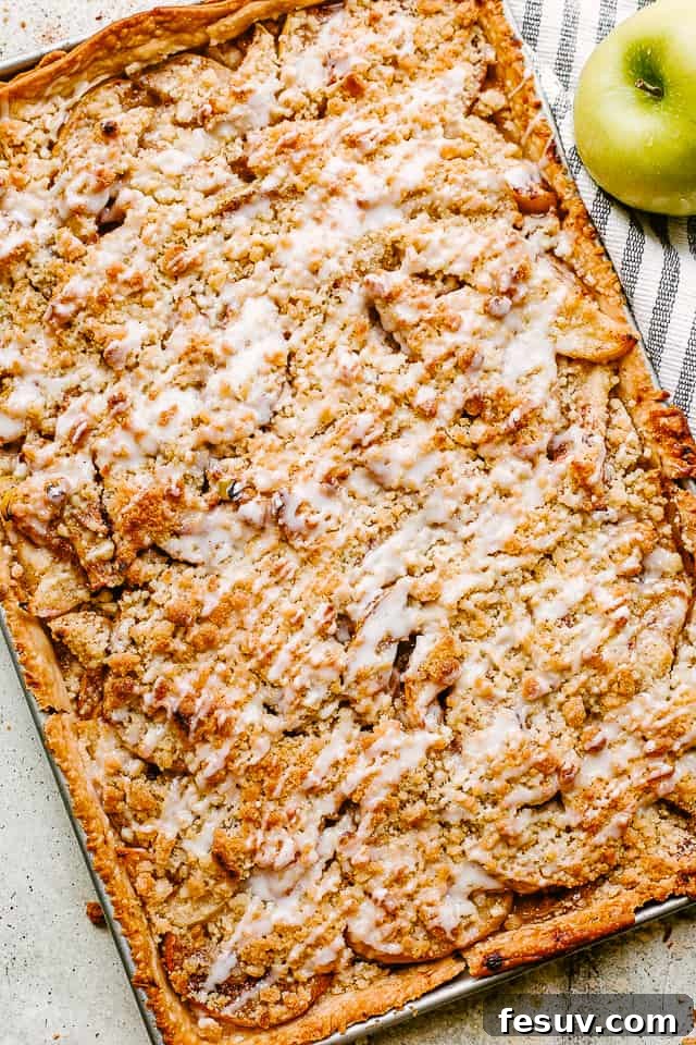 Top view of a whole Dutch apple slab pie, golden brown with streusel topping and glaze.